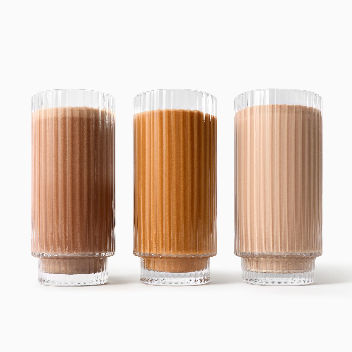 Three glasses with Beauty Pie Protein Powder