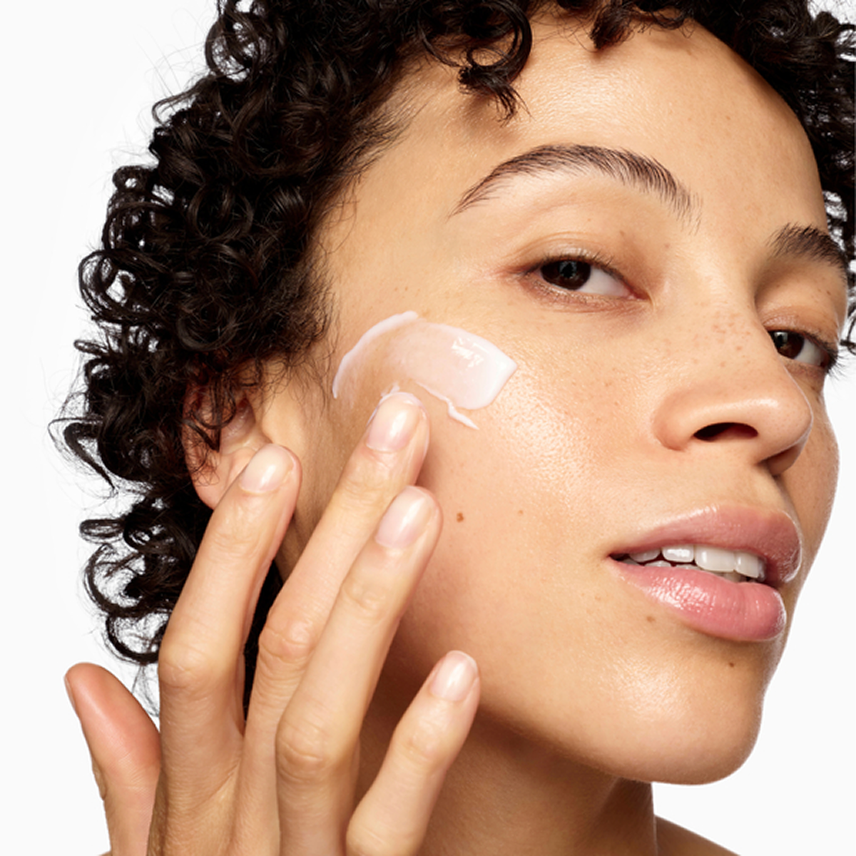 Woman applying Beauty Pie moisturiser